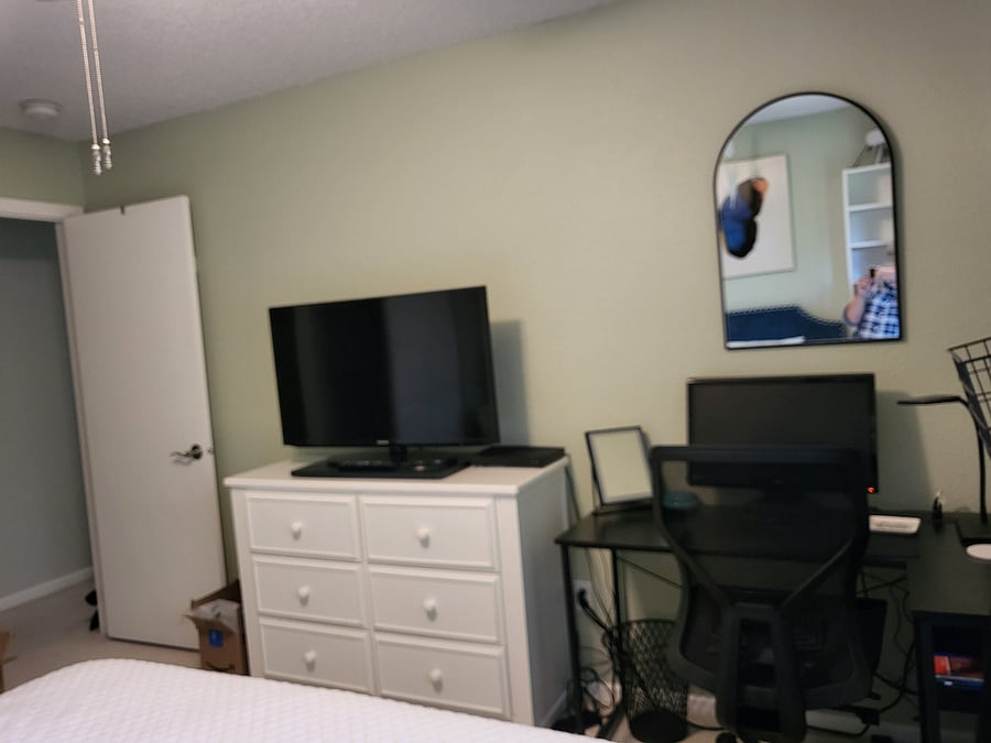 Guest Bedroom has desk w/chair, computer monitors, Smart T.V., dressers and bookshelf.