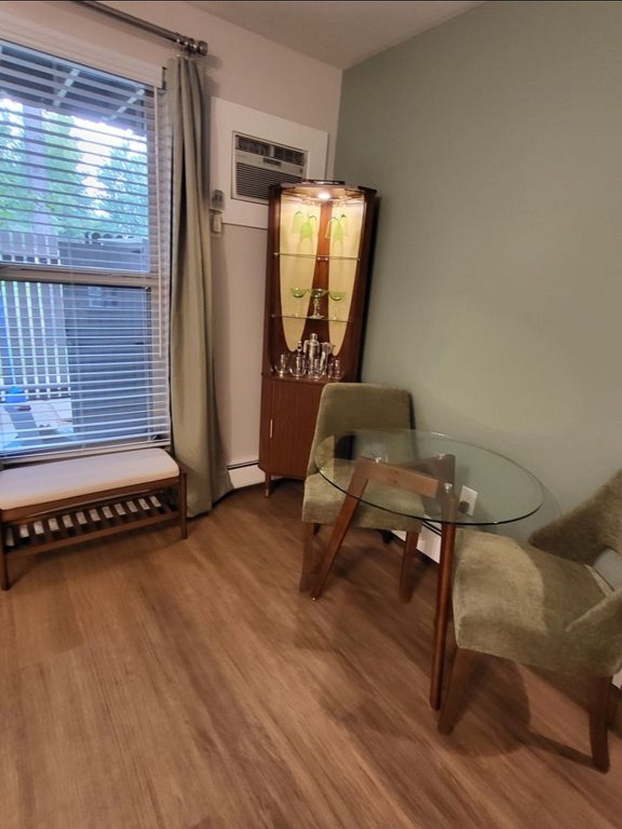 Barking cabinet with glasses and dining table at Niwot Apartment.