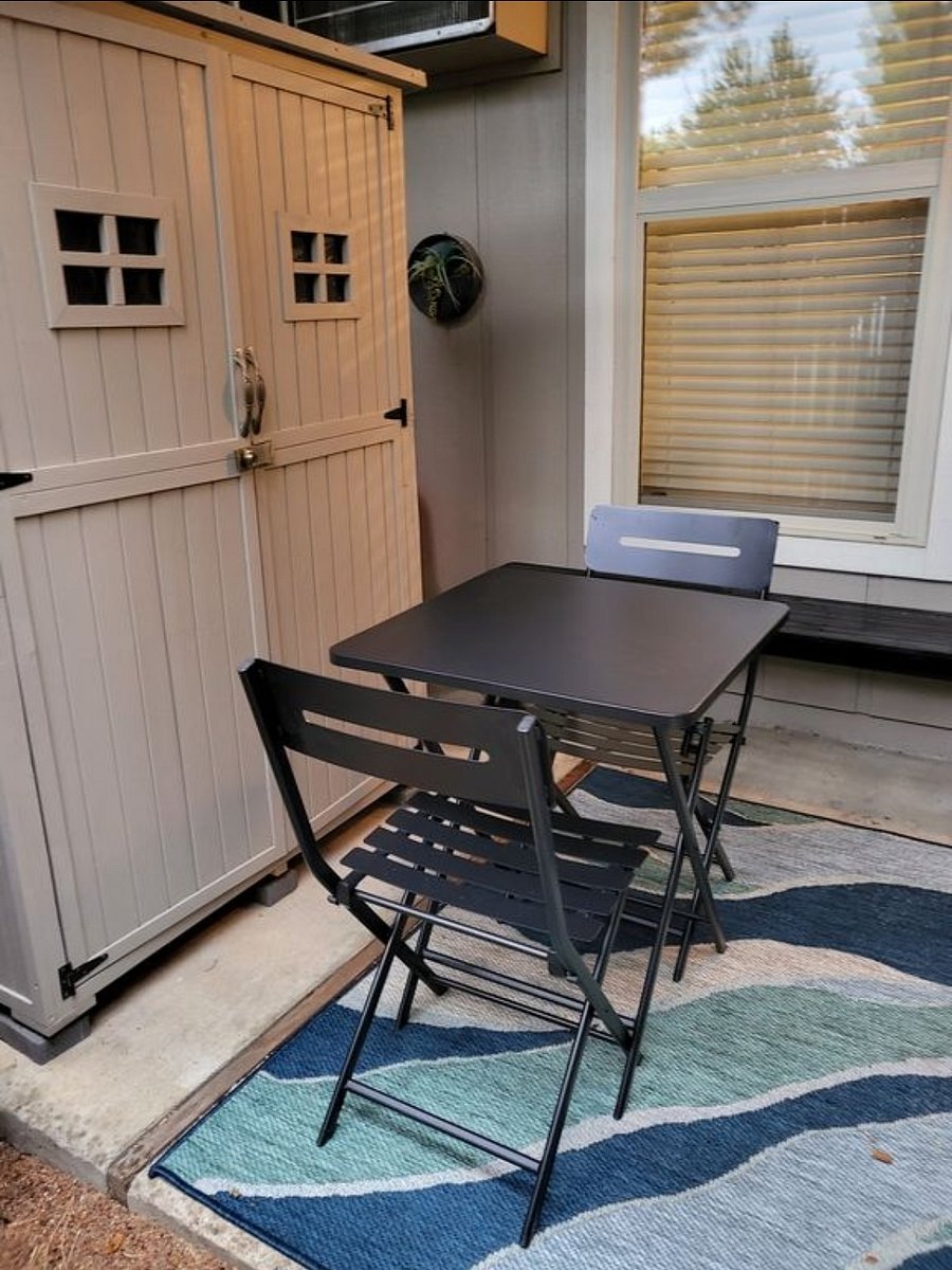Bistro table and chairs and small storage shed in patio to Niwot Apartment