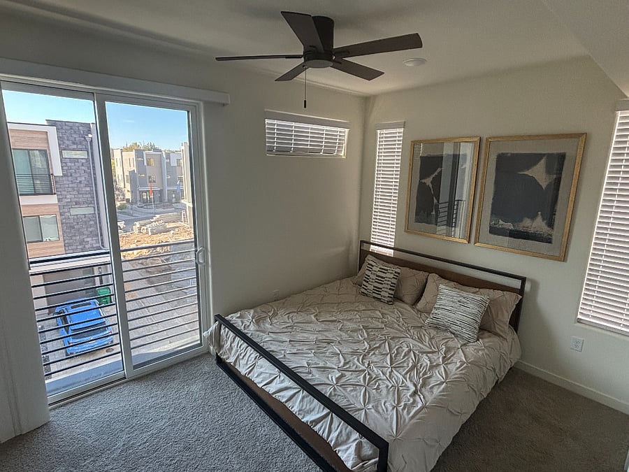 Guest bedroom with juliet window balcony, king bed, and in-room full bath