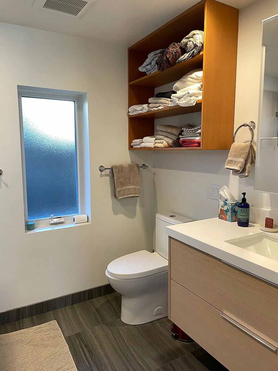 The bathroom has radiant floor heating and a rain shower.