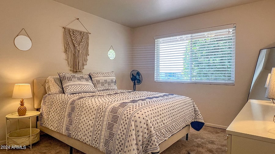 Guest bedroom with queen bed, dresser & closet
