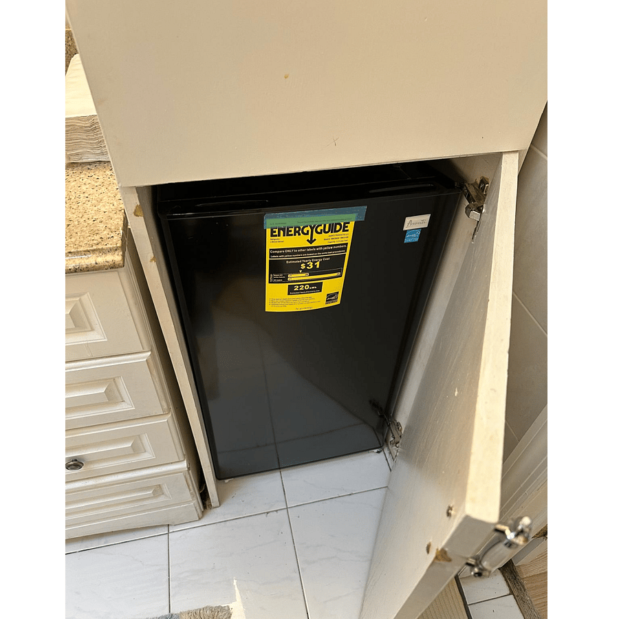 small mini fridge inside the bathroom.
