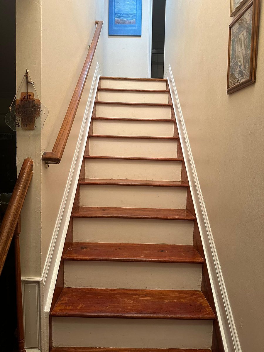 The door to the room is just up the stairs and straight down the hallway towards the back of the house.