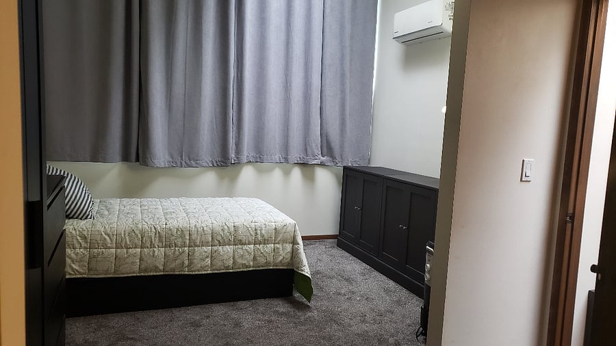 Single room with computer desk and shared bathroom