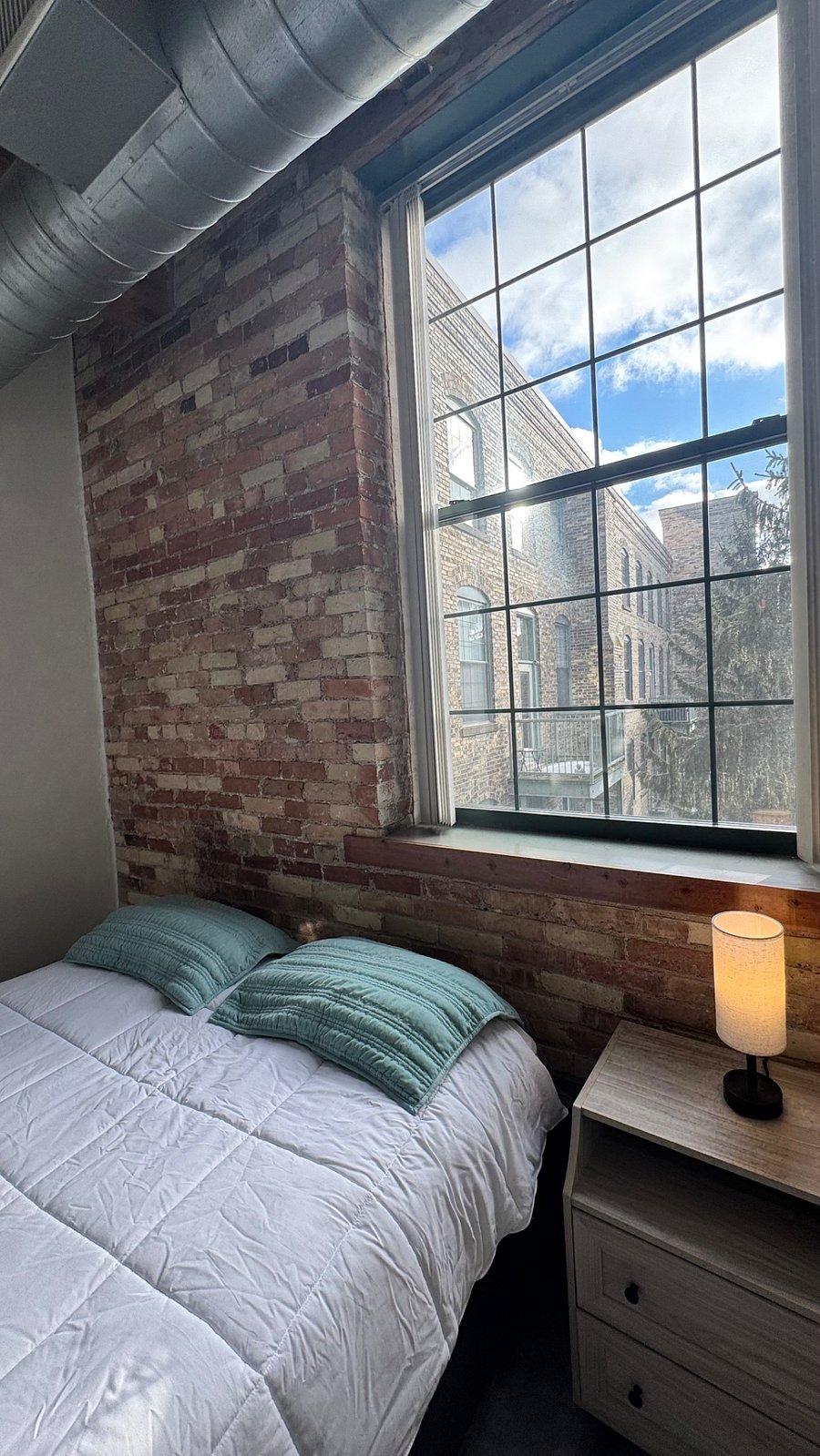 Bedroom #1, window view to south, facing nature garden & exterior of condos on 4th floor