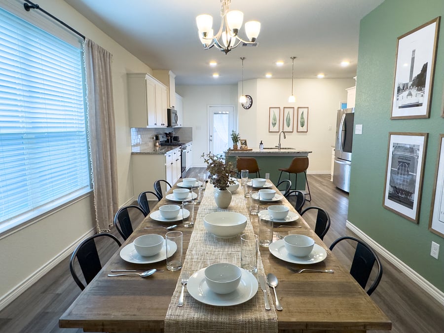 Dining sits in between kitchen and living room. It's a great open concept living space.