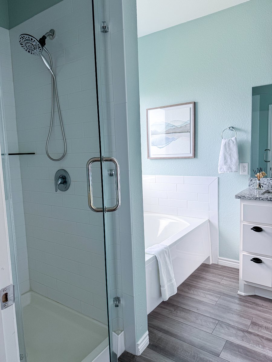 Primary bedroom has a shower and soaker tub.