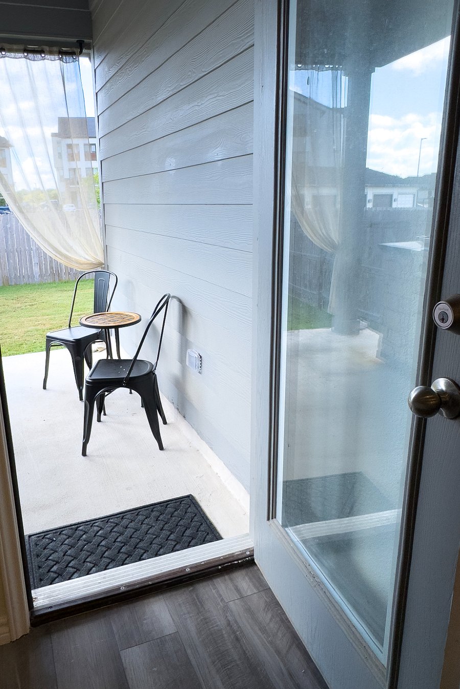Back patio off of kitchen opens onto the backyard.
