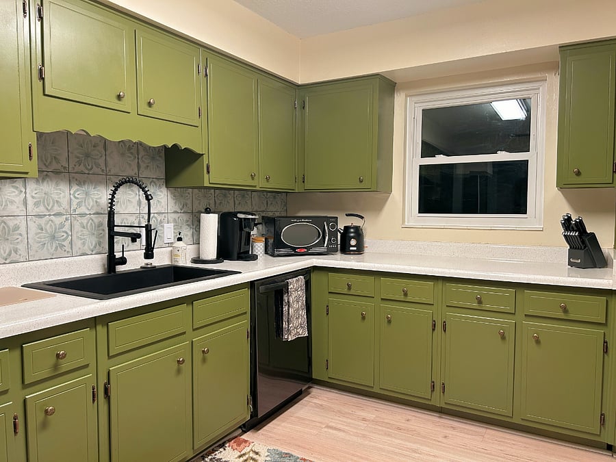 Squeaky Clean kitchen with new floors, counters, and tile backsplash.