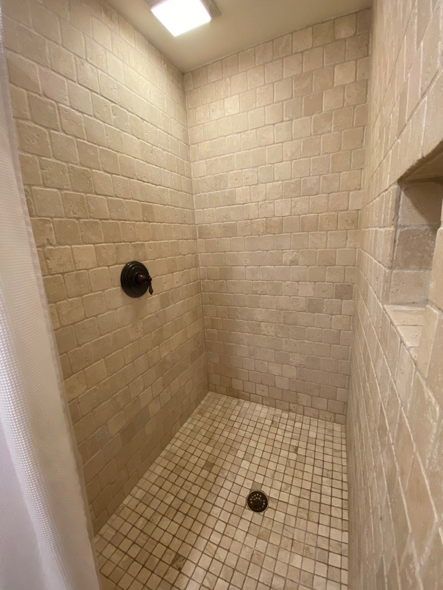 Tumbled travertine rain shower