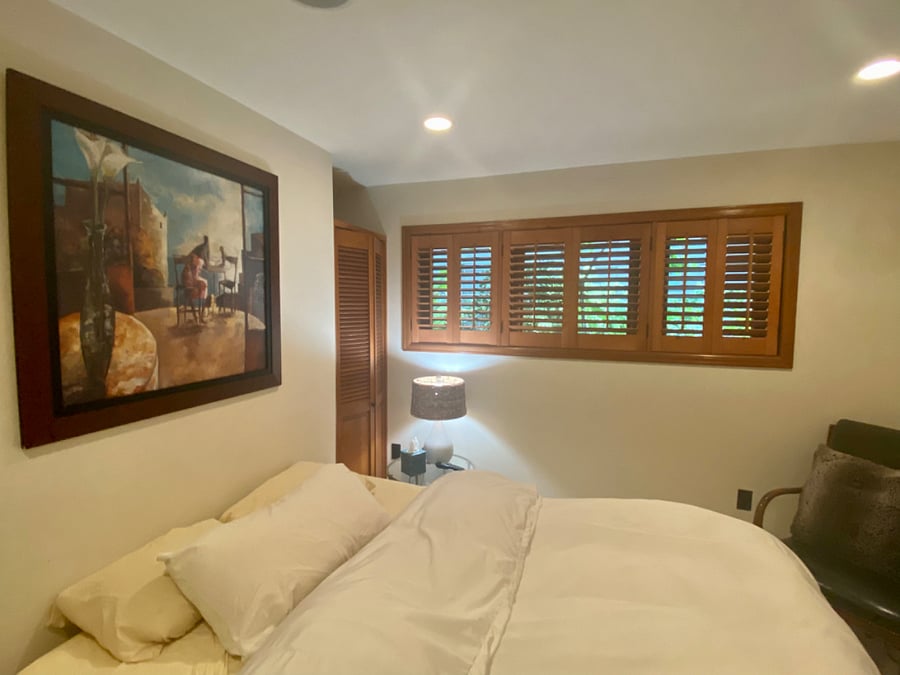 Plantation shutters offer complete privacy. Screens on all windows. View of side garden.