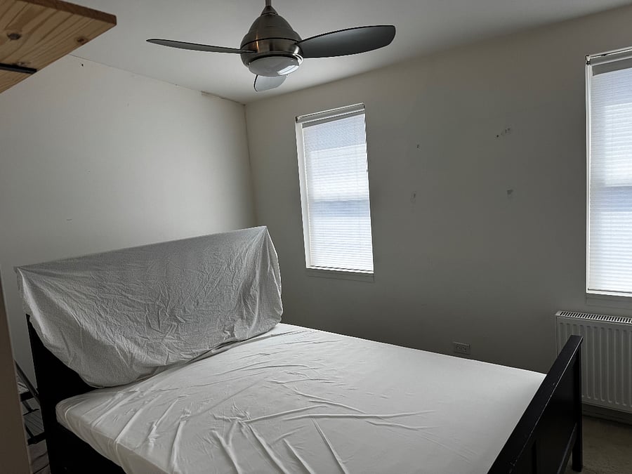 We're painting the bedroom. Queen bed with tables, fan, shelving