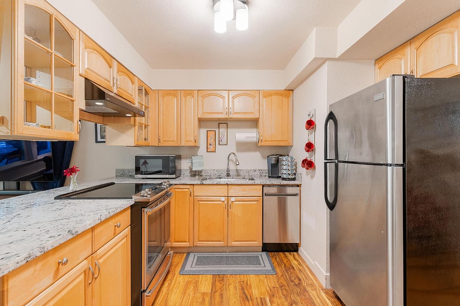 The kitchen is stocked with dishes. There is a brand new garbage disposal and brand new dishwasher.