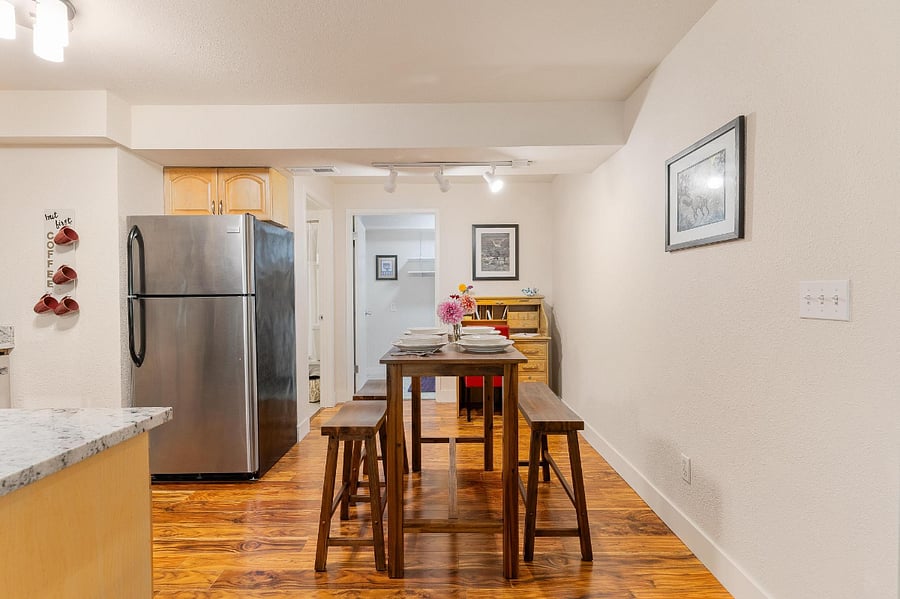 Dining table with seating for 4. The dining table can be moved out to allow 4 to sit, or remain pushed against the wall for 2 seats and to create more space in the apartment.