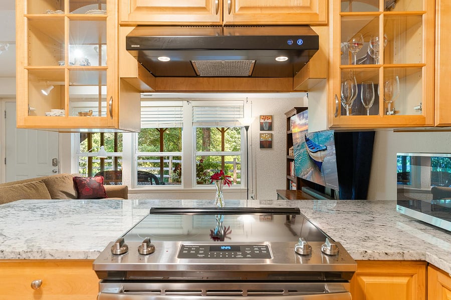 Full stove and oven with a view of the forest while you cook.