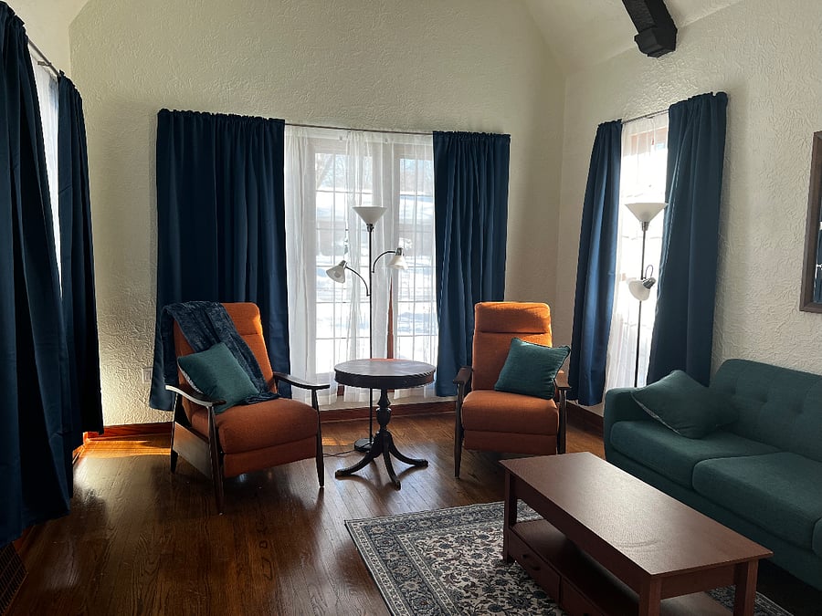 Eastern windows with dual recliners. Long couch for plenty of seating. Coffee table with rising top for work space or snacks.