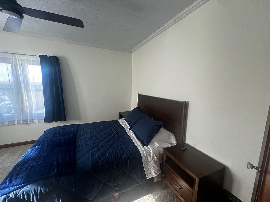 Primary bedroom with remote light/ceiling fan. 2 night stands.