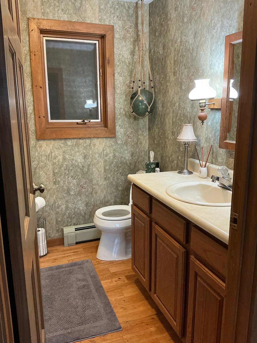 Main level bathroom with laundry chute, and bathtub