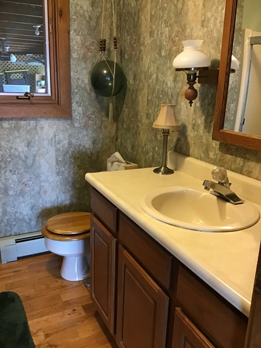 Main level bathroom with laundry chute, and  bathtub
