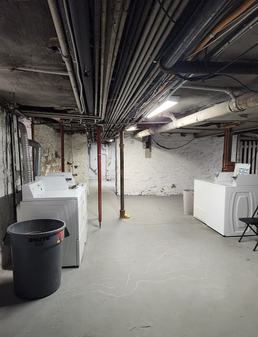 Coin operated washer and dryer in basement.