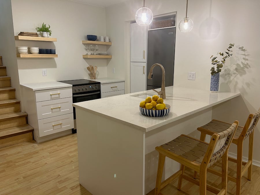 Kitchen with quartz countertops,  full size refrigerator, dishwasher, pantry space and more