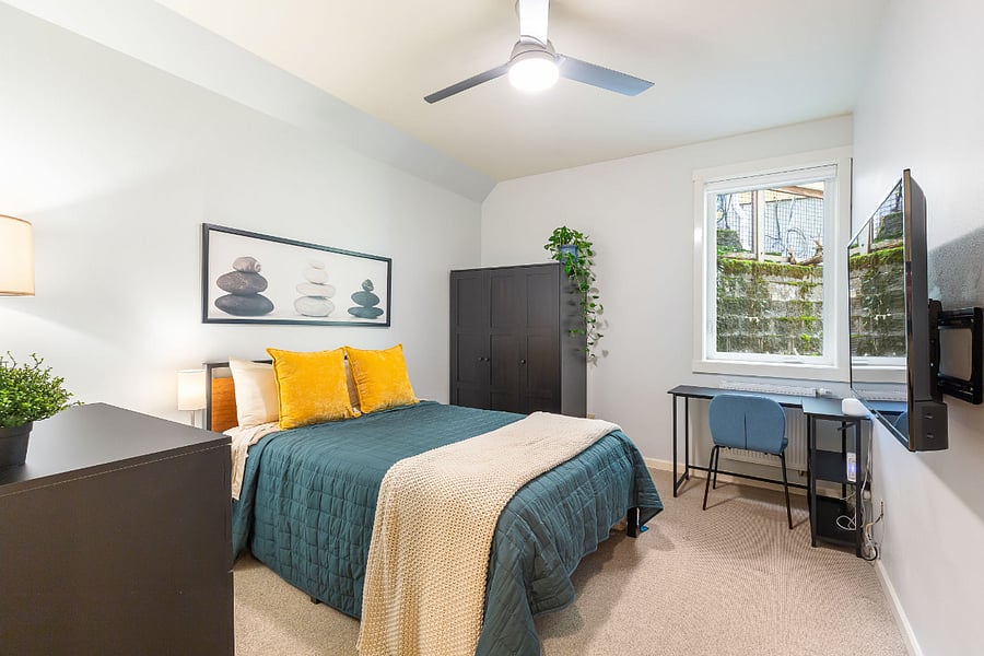 Bedroom number 3 in the downstairs includes a full-sized bed with a high-quality mattress, blinds, smart TV, wardrobe, large dresser, and small desk.