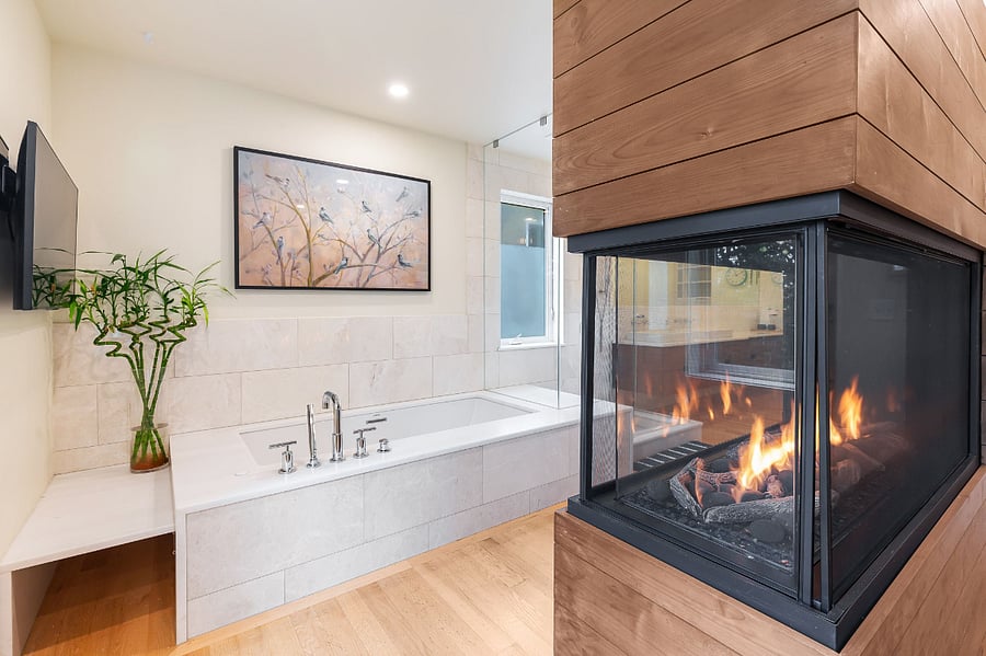 The peninsula fireplace serves both the bedroom and a large soaking tub in the main bedroom.