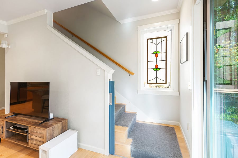Stairs to the lower level of the house enter directly into the living room.