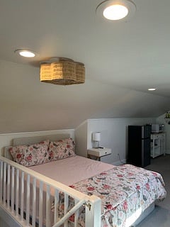 Fan above bed, also has window unit AC.