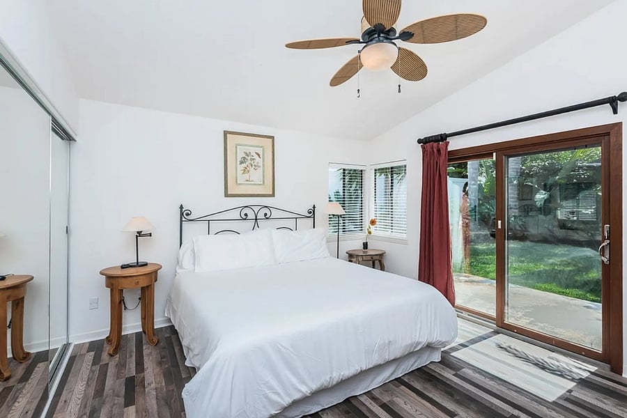 Primary bedroom with sliding glass door to backyard