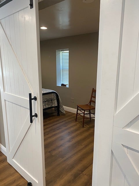 Behind the first barn door to the left, you step into a cozy bedroom that gives the vintage charm.