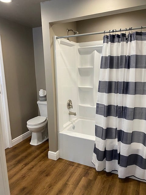 
The large bathroom, located conveniently right off the kitchen, boasts a clean and modern design, offering both functionality and ample storage.