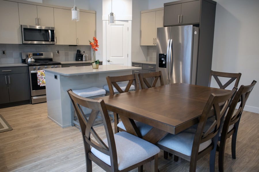 Dining table seats 6, with 2 additional seats at the island
