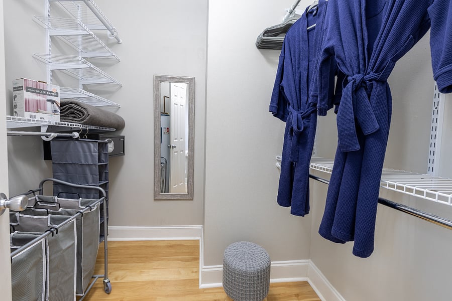 Walk-in closet with cotton bath robes and built-in security safe.