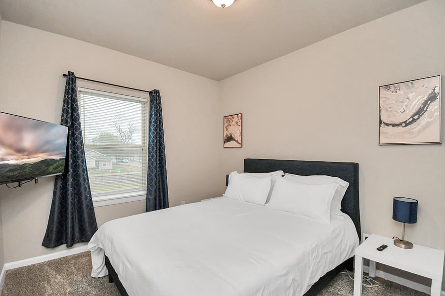 Unit B: Guest room with a Queen size bed and blackout curtains.