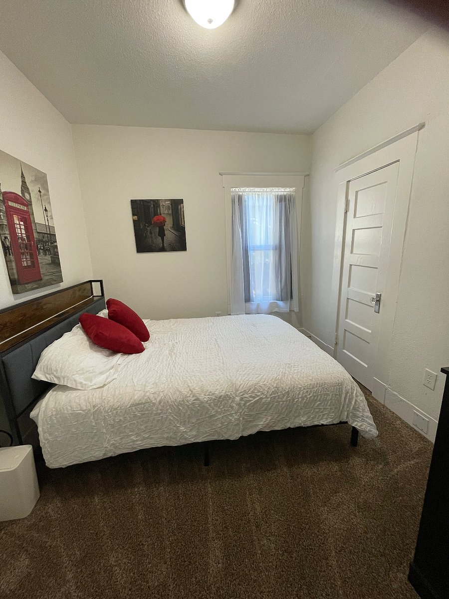 Queen bed with dresser and closet.  Bed frame headboard has a built in charging station.
