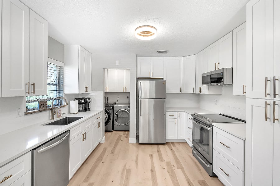 Kitchen with adjacent laundry area.