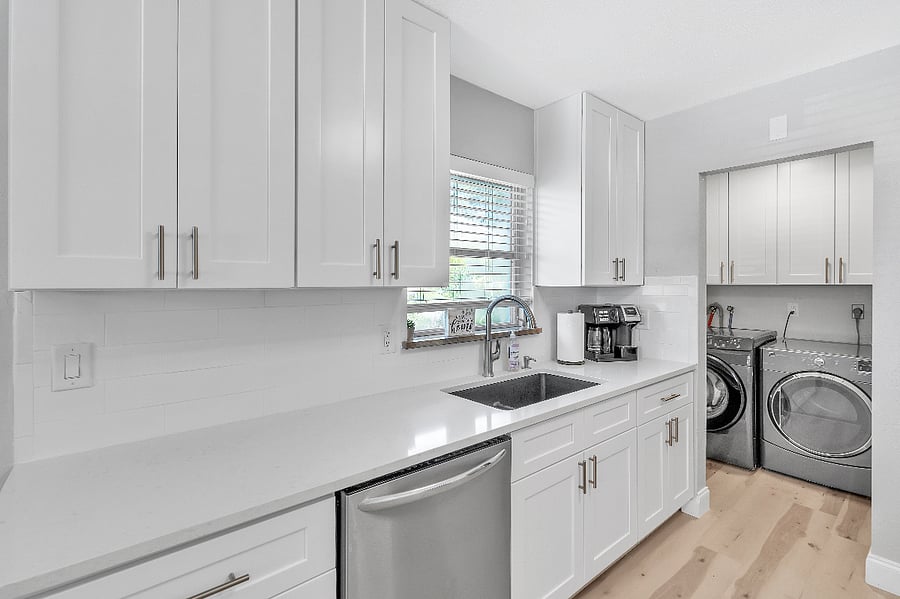 Kitchen with adjacent laundry area.
