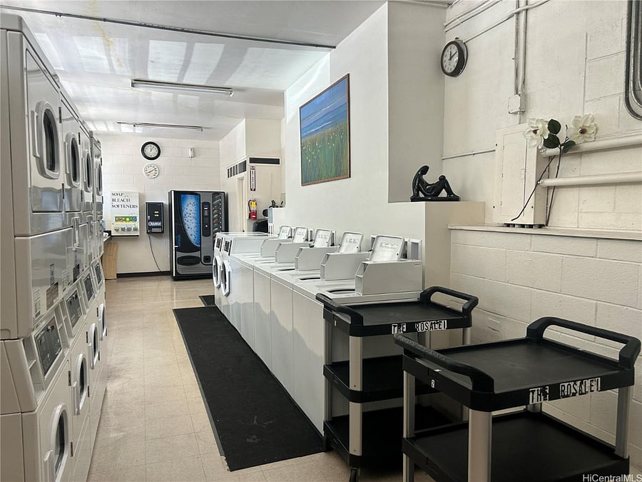 Coin/app-operated laundry room on premises  washers, dryers, and folding area.