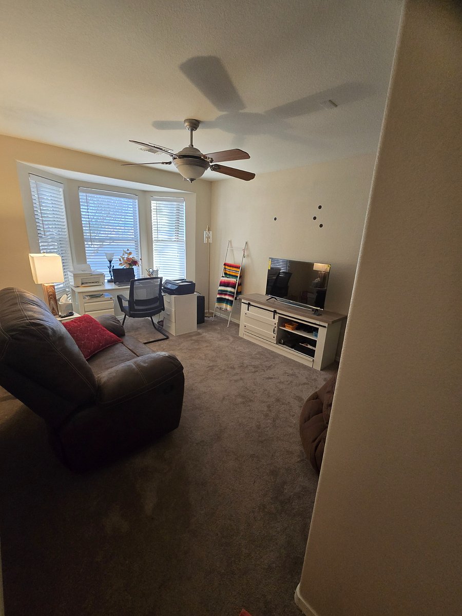 Bedroom area converted into office space. File cabinets present.