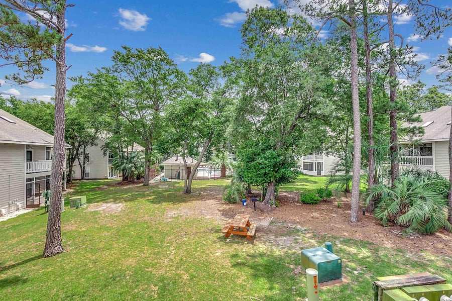Common central picnic area behind the condo, between the unit and the pool.