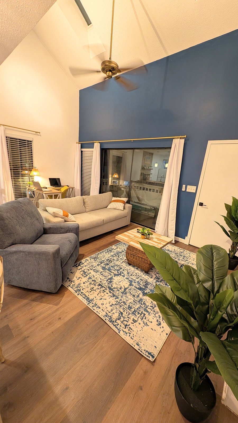 Spacious Living room with 55 inch Smart TV and Electric fireplace. Features a 17 ft fireplace wall.