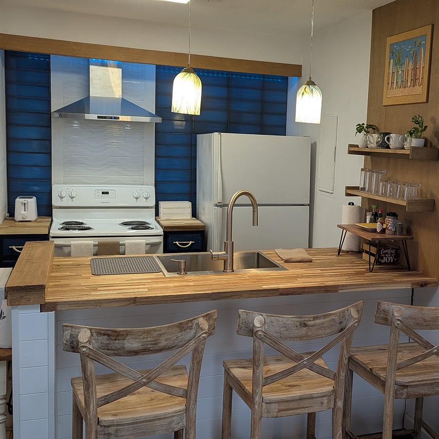 Amazing custom designed kitchen with Italian tile, 50's-60's wood touches. Brilliant multi-colored recessed LED alcove to suit whatever mood you want! Designer, deep stainless steel sink and faucet.