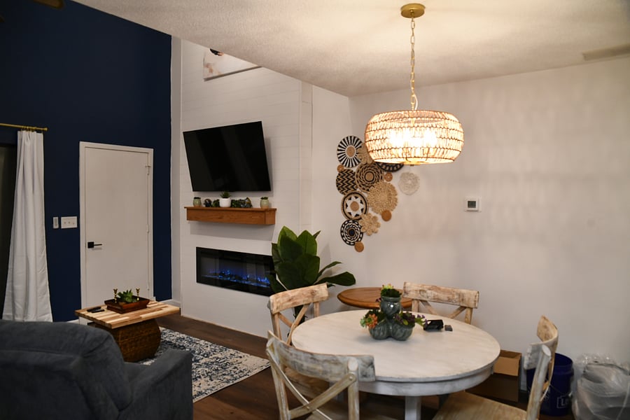 Spacious Living room with 55 inch Smart TV and Electric fireplace. Features a 17 ft fireplace wall.
