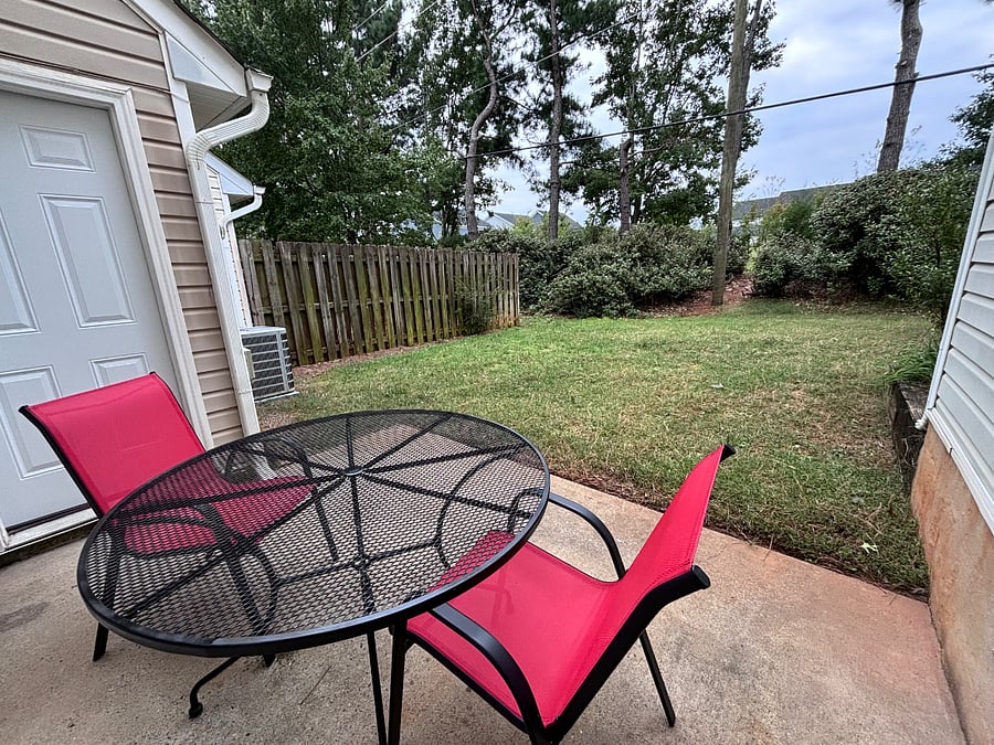 Sitting area in back porch. Yard is now fenced.