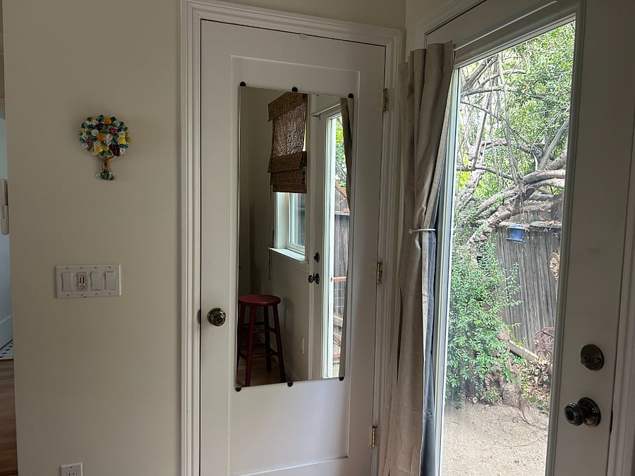 Closet with organization system including hangers and drawers inside.