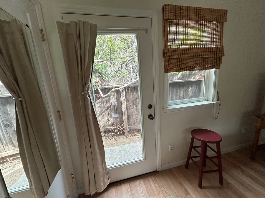 Door out to private back patio. Both bedroom doors have blackout curtains.