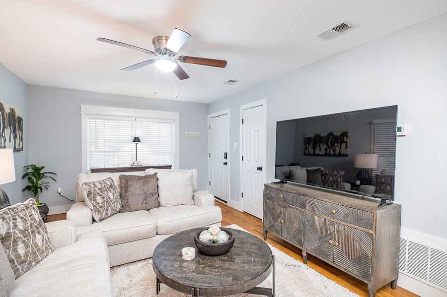 The dining table is located in the living room along window. It has dual purpose of dining and working with a plug and usb port integral in the table.