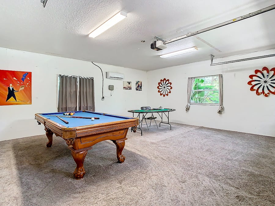The 2 car garage has been converted to a playroom with a pool table and a ping pong table.